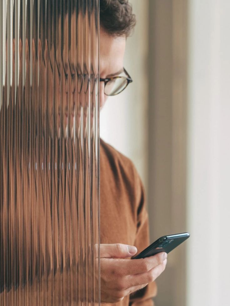 A man checking his phone, the way prospective clients look up a law firm