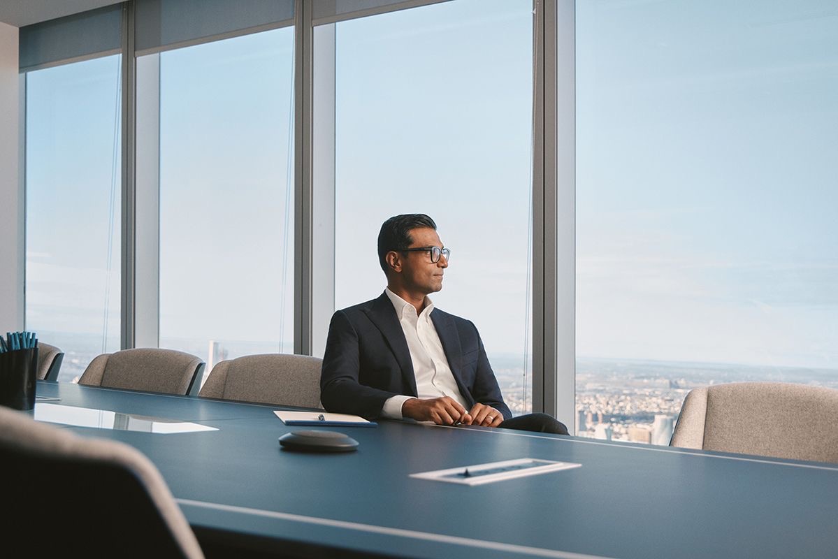 Attorney seated at a conference table overlooking the city